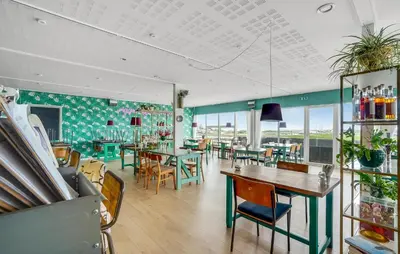 a restaurant with tables and chairs and windows at Amazing Home In Vestervig With Sauna in Vestervig