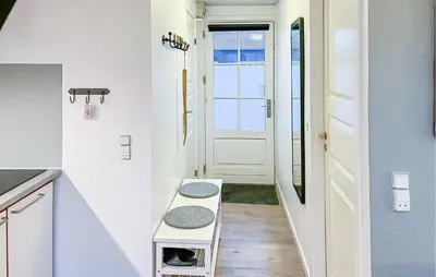 a hallway with a door and a bench in a room at Amazing Home In Vestervig With Sauna in Vestervig