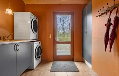 a laundry room with a washer and dryer at Cozy Home In Spøttrup With Sauna in Spottrup