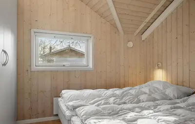 a bedroom with a bed and a window at Gorgeous Home In Vinderup With Sauna in Vinderup