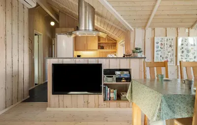 a living room with a tv and a table with a table sidx sidx at Gorgeous Home In Vinderup With Sauna in Vinderup