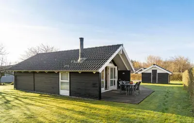 a small house with a deck in the yard at Gorgeous Home In Vinderup With Sauna in Vinderup