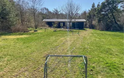 a soccer goal in a field with a building at 4 Bedroom Amazing Home In Hurup Thy in Sønder Ydby
