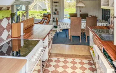 a kitchen and dining room with a dining table at 4 Bedroom Amazing Home In Hurup Thy in Sønder Ydby