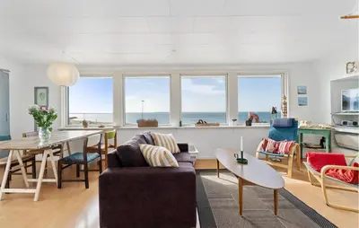 a living room with a couch and a table at 2 Bedroom Stunning Home In Øster Assels in Øster Assels