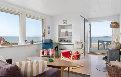 a living room with a view of the ocean at 2 Bedroom Stunning Home In Øster Assels in Øster Assels