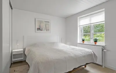 a white bedroom with a bed and two windows at Stunning Home In Fjerritslev With Sauna in Fjerritslev