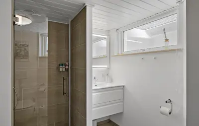 a bathroom with a sink and a shower at Stunning Home In Fjerritslev With Sauna in Fjerritslev