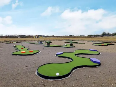 a bunch of green golf balls on a field at 4 star holiday home in Brovst in Brovst