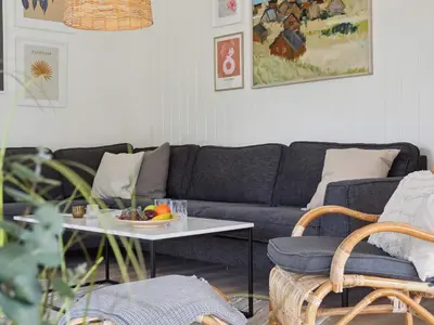a living room with a couch and a table at 5 star holiday home in Løkken in Løkken