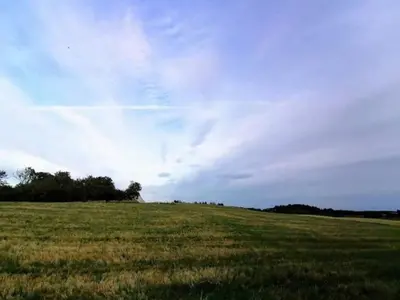 a field of grass with a cloudy sky at 5 star holiday home in Løkken in Løkken