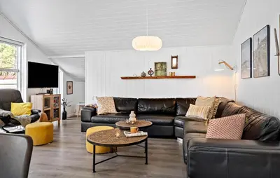 a living room with leather couches and a table at Stunning Home In Hurup Thy With Sauna in Sønder Ydby