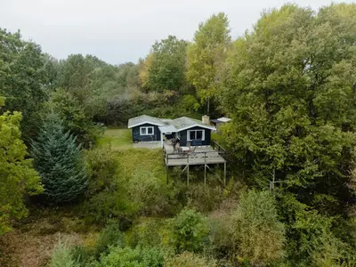 an aerial view of a house in the woods at Cozy Holiday Home With Forest And Fjord Views in Roslev