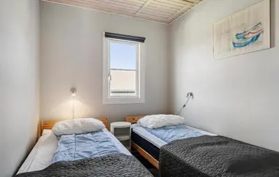 two beds in a room with a window at Stunning Home In Vestervig With Sauna in Vestervig