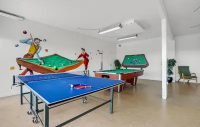 a room with two ping pong tables and billards at Stunning Home In Vestervig With Sauna in Vestervig