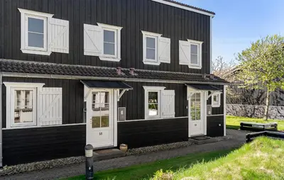 a black house with white doors and windows at Stunning Home In Vestervig With Sauna in Vestervig