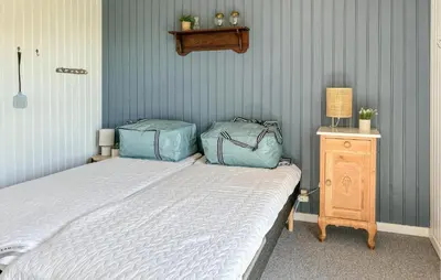 a bedroom with a bed with two bags on it at 3 Bedroom Nice Home In Fjerritslev in Fjerritslev