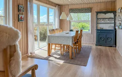 a kitchen and dining room with a table and chairs at 3 Bedroom Nice Home In Fjerritslev in Fjerritslev