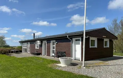 a small cabin with a porch and a pole at 3 Bedroom Nice Home In Fjerritslev in Fjerritslev