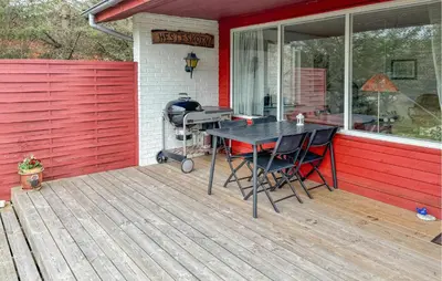 a patio with a table and chairs on a deck at Lovely Home In Fjerritslev With Wifi in Fjerritslev