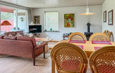 a living room with a table and chairs and a couch at Lovely Home In Fjerritslev With Wifi in Fjerritslev
