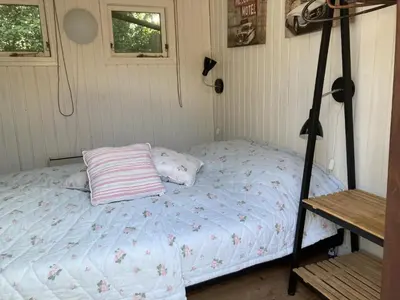 a small bed in a room with a tripod at PipOp - the place where you find your soul again in Struer