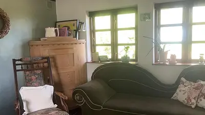 a living room with a couch and two windows at PipOp - the place where you find your soul again in Struer