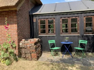 two chairs and a table in front of a shed at PipOp - the place where you find your soul again in Struer