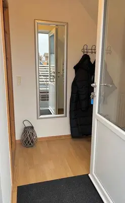 a room with a door and a mirror and a hallway at Bright Nordic Loft Apartment in Spottrup