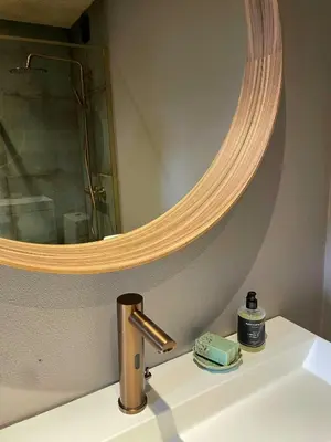 a bathroom sink with a mirror and a faucet at Modern Wooden House Near Halkær Bredning in Nibe