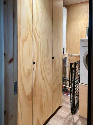 a couple of wooden cabinets in a room with a washing machine at Modern Wooden House Near Halkær Bredning in Nibe