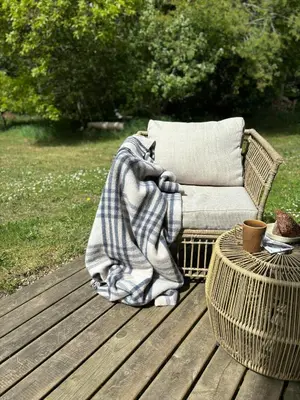 a blanket sitting on a couch on a wooden deck at Hidden Gem By Thy National Park