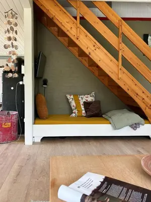 a bench under a stairs with pillows on it at Hidden Gem By Thy National Park