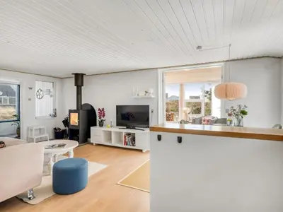 a kitchen and living room with white walls at Holiday Home Mynthe - 500m from the sea by Interhome in Thisted