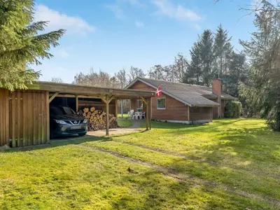 a house with a car parked in front of it at Holiday Home Franzisca - 200m to the fjord by Interhome in Roslev