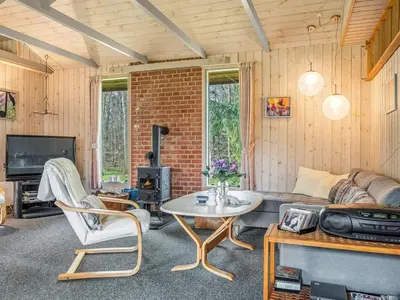 a living room with a couch and a table at Holiday Home Franzisca - 200m to the fjord by Interhome in Roslev