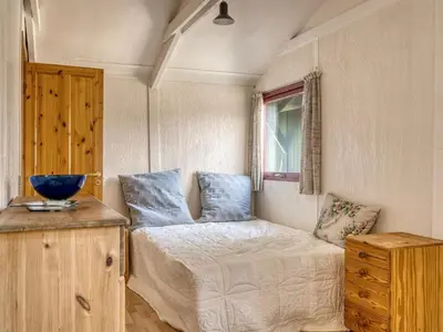 a small bedroom with a bed and a window at Holiday Home Nimrod - 800m from the sea by Interhome in Blokhus