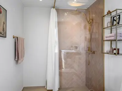 a shower with a white shower curtain in a bathroom at Holiday Home Heidl - 2km from the sea by Interhome in Blokhus