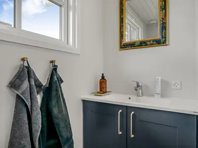 a bathroom with a sink and a mirror at Holiday Home Jork - 1km from the sea by Interhome in Saltum
