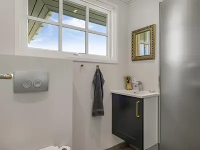 a bathroom with a sink and a window at Holiday Home Jork - 1km from the sea by Interhome in Saltum