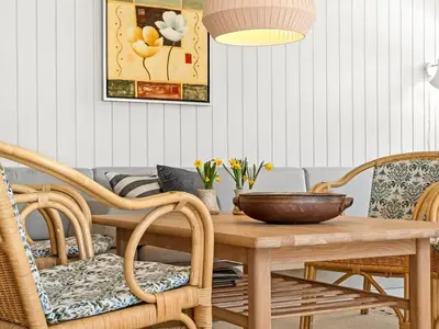 a dining room with a wooden table and chairs at Holiday Home Jork - 1km from the sea by Interhome in Saltum