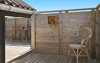 a wooden deck with a chair and a table at 3 Bedroom Gorgeous Home In Lemvig in Lemvig