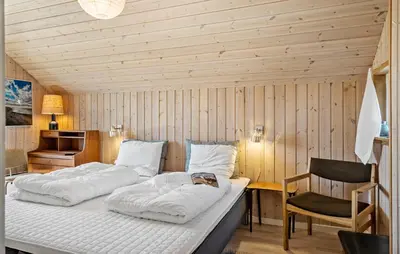 two beds in a room with a desk and a chair at 3 Bedroom Gorgeous Home In Lemvig in Lemvig