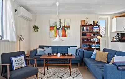 a living room with blue couches and a table at 3 Bedroom Gorgeous Home In Lemvig in Lemvig