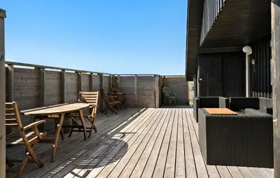 a wooden deck with tables and chairs on it at 3 Bedroom Gorgeous Home In Lemvig in Lemvig