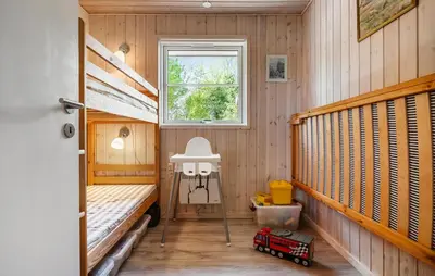 a room with two bunk beds and a window at 3 Bedroom Nice Home In Farsø in Farsø