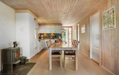 a kitchen with a table and chairs and a stove at 3 Bedroom Nice Home In Farsø in Farsø