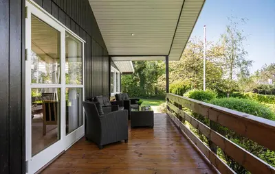 a screened porch with chairs on a house at 3 Bedroom Nice Home In Farsø in Farsø