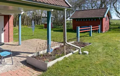 a garden in front of a house with a shed at Nice Home In Roslev With Wifi in Roslev