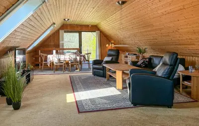 a living room with a couch and a table at Nice Home In Roslev With Wifi in Roslev